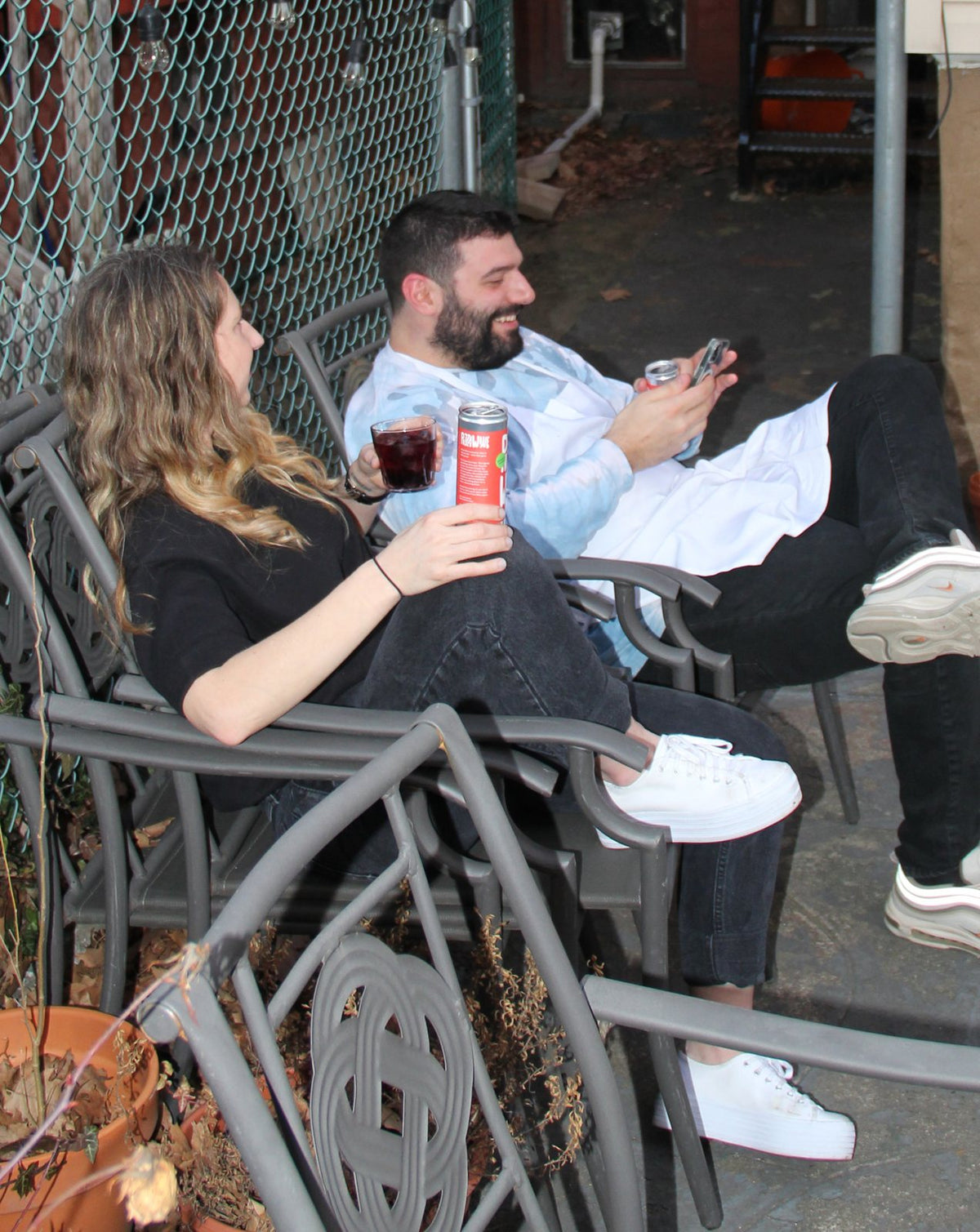 Liz and Rob relaxing in a backyard with Pizza Wine