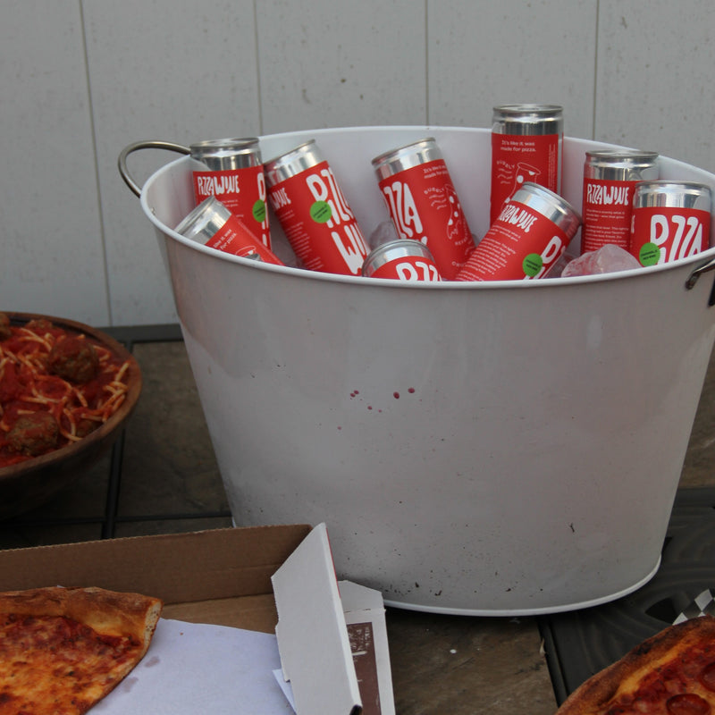A bucket of Pizza Wine cans at a pizza party