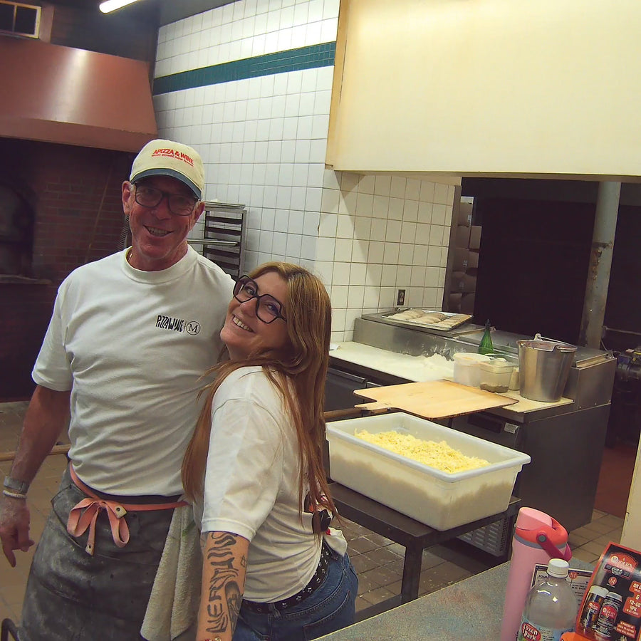 Billy from Modern Apizza in the kitchen wearing the APIZZA & Wine hat and Modern x Pizza Wine tee